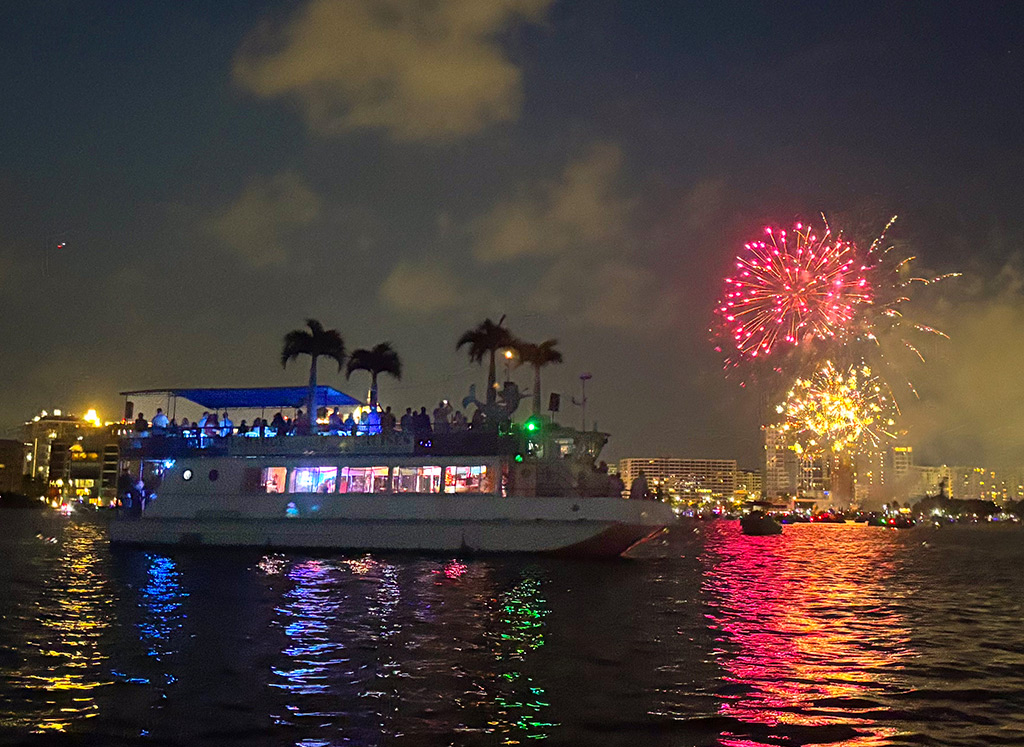 Fireworks over water with boat