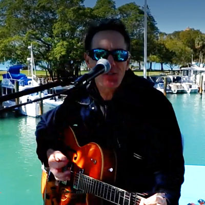LeBarge-Tropical-Cruises-Musician-Ted Musician playing on boat in sarasota bay