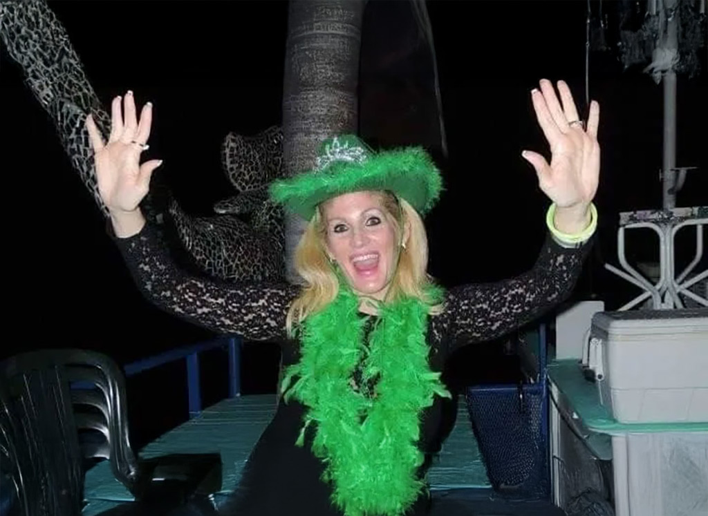 Woman with green hat and decorations having fun on St. Patrick's Day